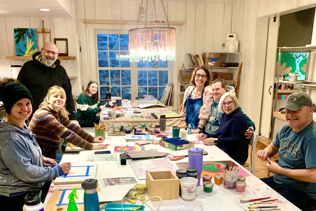 Group of Lightspire artists smiling and posing for a photo in the studio