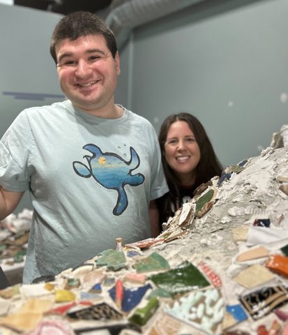 Two artists working with mosaic at Lightspire studio